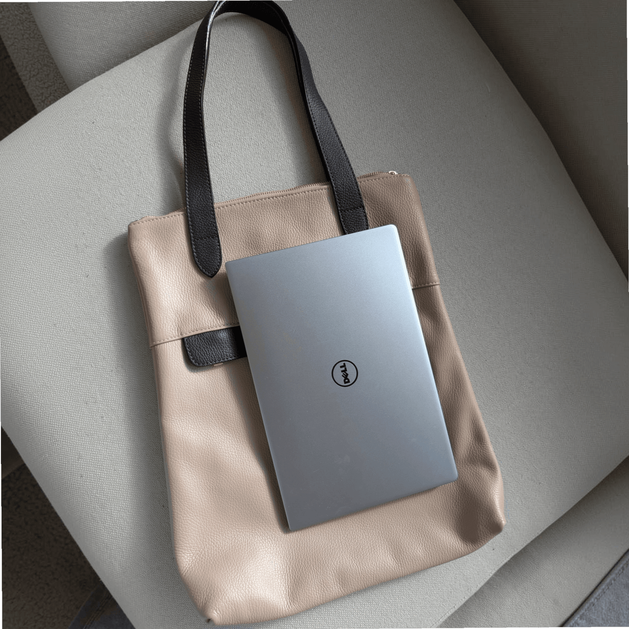 13-inch laptop lying vertically on top of the dusty pink Liali pebbled leather shopper, House of Enira