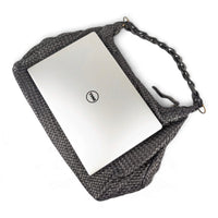 13-inch laptop resting horizontally on top of the black Talisca hobo bag, House of Enira
