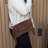 marron Italian suede bag with fringe, adjustable strap, and square-slouch shape