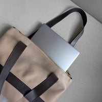 13-inch laptop slipped vertically into the dusty pink Liali pebbled leather shopper, House of Enira